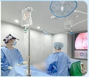 Surgical team performing breast surgery while watching the endoscope monitor
