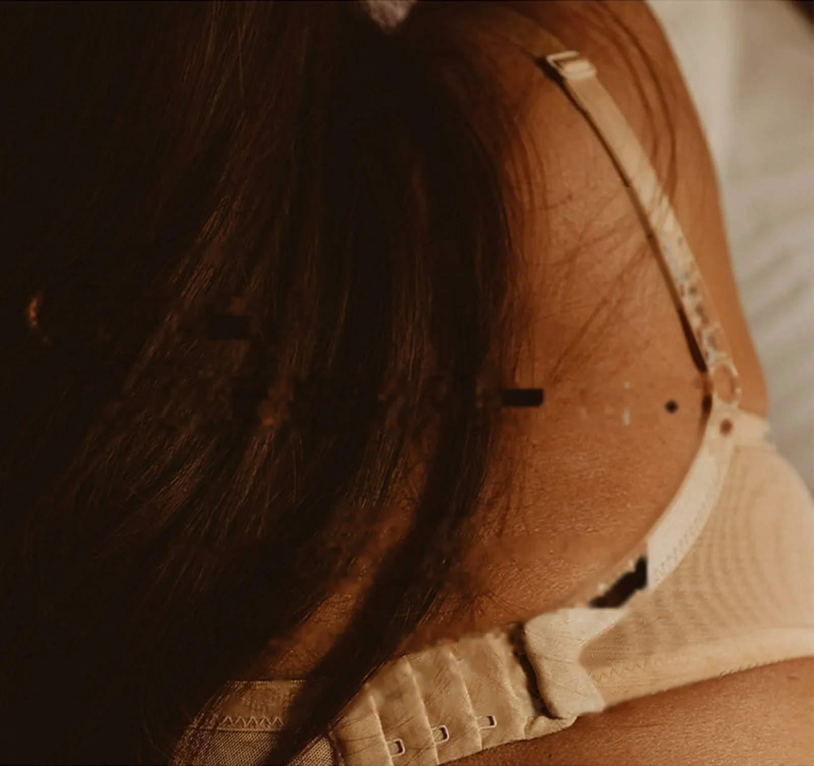 Close-up of a bra hook on a woman's back